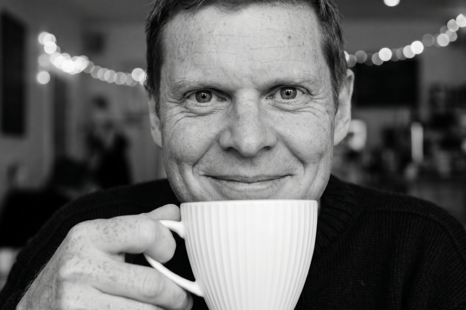 Portrait of Marc Winn holding a coffee cup